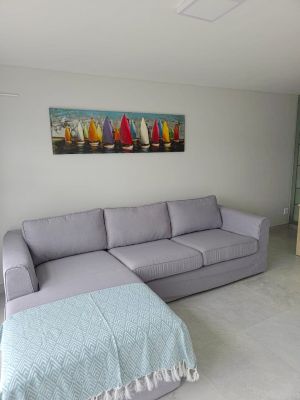 grey couch with boat painting above